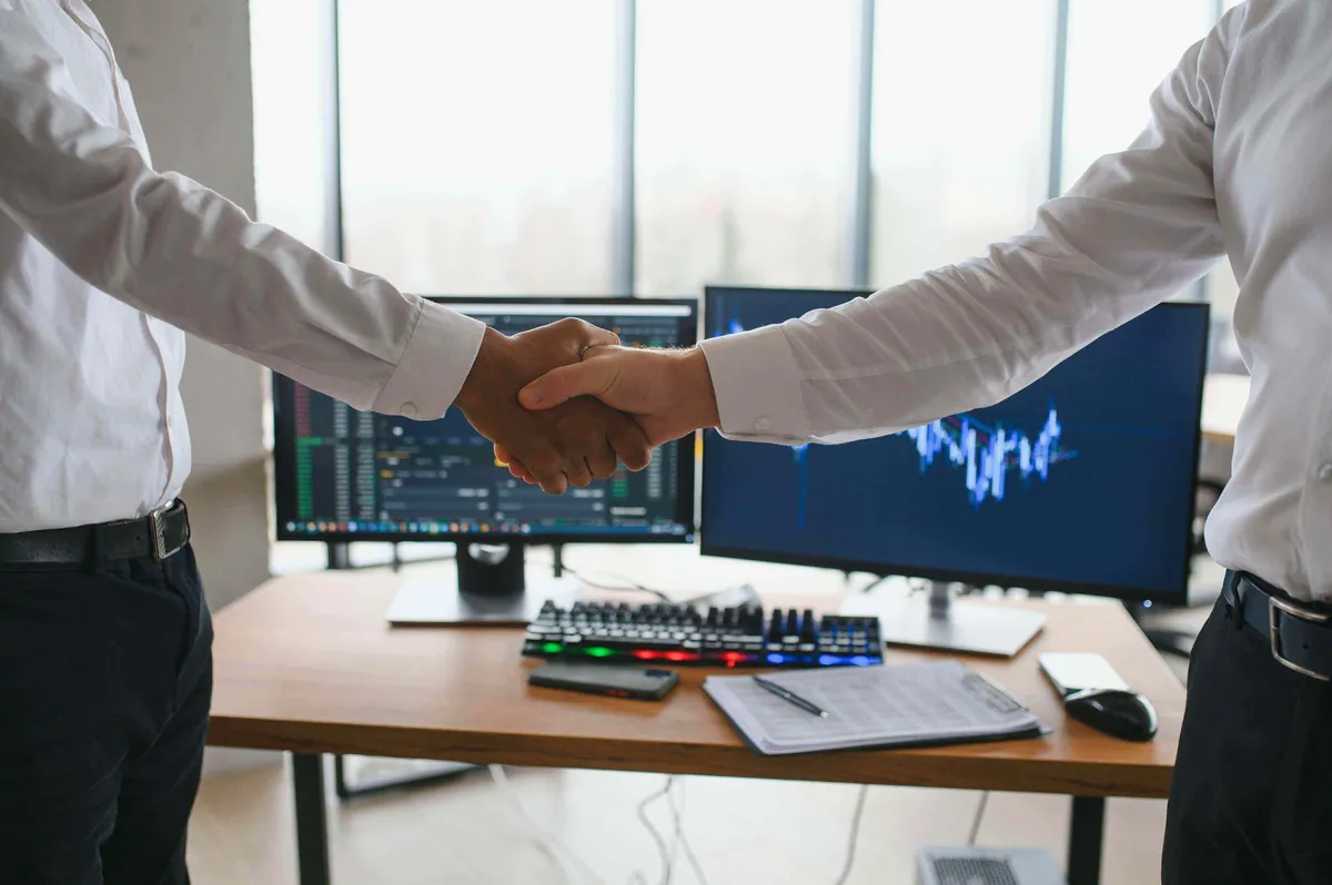 Handshake between a business owner and a technology consultant, sealing a strategic digital transformation partnership